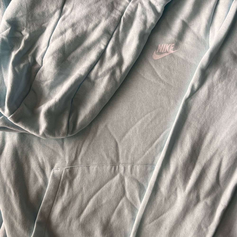 A light blue color sweatshirt by the brand nike
